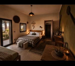 a bedroom with a bed and a table in a room at Etna Country Home in Nicolosi