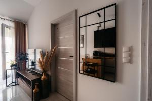 a hallway with a desk and a mirror at Panorama Silva in Augustów