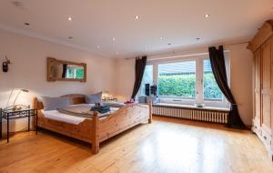 a bedroom with a large bed and a large window at Haus Strandkind in Sylt