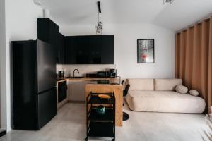 a living room with a couch and a kitchen at Panorama Silva in Augustów