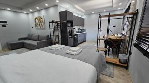 a bedroom with a bed and a kitchen with a table at Dereboyu Premium in Nicosia