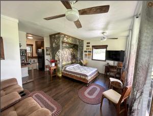 a bedroom with a bed and a living room at The bunkhouse in Sarasota