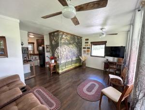 a living room with a couch and a ceiling fan at The bunkhouse in Sarasota