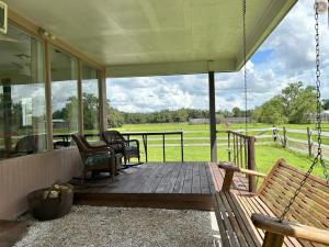 a porch with benches and a view of a field at The bunkhouse in Sarasota