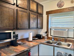a kitchen counter with a microwave and a sink at The bunkhouse in Sarasota