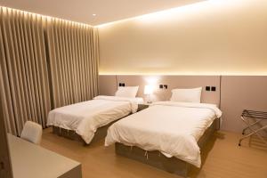 two beds in a hotel room with white sheets at فندق دواد الدوادمي Dewad Hotel in Ad Dawādimī +53 photos