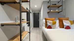 a bedroom with a bunk bed with orange and white pillows at The Coal Yard in York