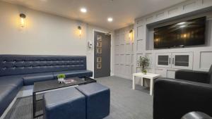 a living room with a blue couch and a tv at The Coal Yard in York