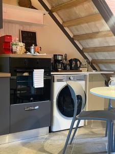 a kitchen with a washing machine and a table at Casa Danesi in Monteleone dʼOrvieto