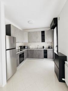 a kitchen with a stainless steel refrigerator and cabinets at Emy Dreams in Citta' Sant'Angelo +5 photos