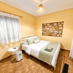 a bedroom with a bed and a window at Olive Coast House 3 100m from the sea in Kyparissia