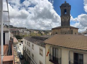 an old building with a clock tower in a city at Alcalá Zona Centro Duplex in Alcalá la Real