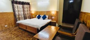 a small room with a bed and a table at The Lake BnB in Nainital