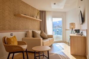 a living room with a couch and a table at Tomir Portals Suites - Adults Only in Portals Nous