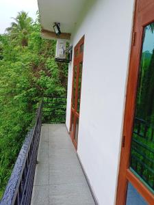 an open door to a building with a balcony at Khs resort in Gelioya