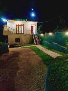 a house at night with the lights on at Khs resort in Gelioya