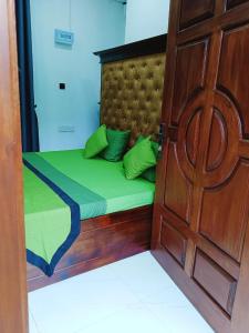 a bed in a room with a wooden door at Khs resort in Gelioya