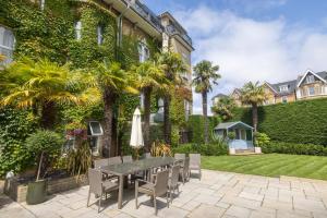 a patio with a table and chairs in front of a building at Connaught Lodge in Bournemouth