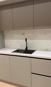 a kitchen with a sink and a counter top at Aura Stay Apartment in Tirana