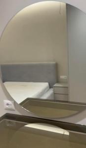 a reflection of a bed in a mirror at Aura Stay Apartment in Tirana +8 photos