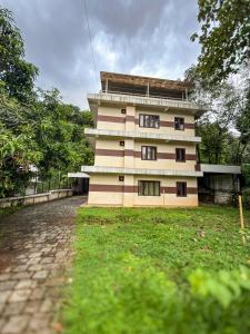 a tall building sitting on top of a brick road at Grand Retreat in Trichūr