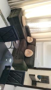 a living room with a couch on the ceiling at Cité La Vie in Douala