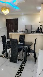 a room with a table and chairs and a counter at Cité La Vie in Douala