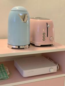 a toaster and a printer sitting on a shelf at stay mongle in Suwon