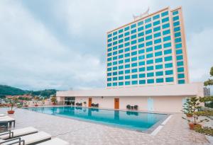 a swimming pool in front of a tall building at Muong Thanh Grand Lao Cai Hotel in Lao Cai