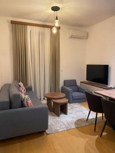 a living room with a couch and a tv at BIJELA apartman 2025 in Bijela