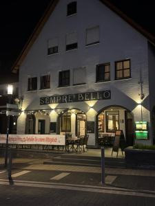 a building with a sign that reads compare bello at Sempre Bello in Iffezheim