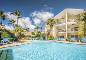 a villa with a swimming pool in front of a building at Ocean Dream - Kite Paradise! in Cabarete