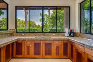 a kitchen with a sink and some windows at Casa Carmen in Potrero +28 photos