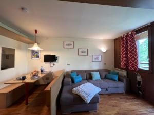 a living room with a couch and a table at Cervinia Mountain View Apartments in Breuil-Cervinia
