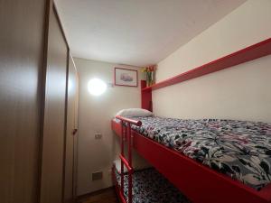 a small bedroom with a bed and a closet at Cervinia Mountain View Apartments in Breuil-Cervinia