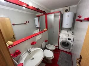 a small bathroom with a sink and a washing machine at Cervinia Mountain View Apartments in Breuil-Cervinia +10 photos