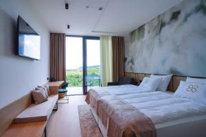 a bedroom with a large bed and a large window at Degenija Boutique hotel & Spa in Seliste Dreznicko +95 photos