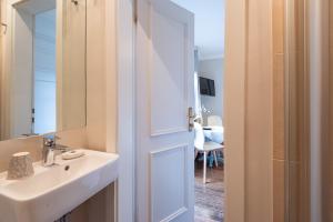 a bathroom with a sink and a mirror at Haus Strandkind in Sylt +40 photos
