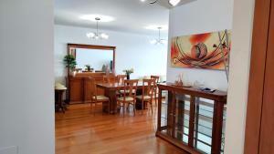 a dining room and living room with a table and chairs at Vista Mar Concórdia by Rentallido in Funchal