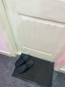 two shoes sitting on a mat in a room at Royal Stays 2Bed Cozy Apartment in Multan