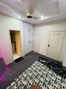 an empty room with a rug on the floor at Royal Stays 2Bed Cozy Apartment in Multan