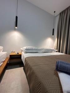 a bedroom with a large bed and a table at Escape by Ambelas in Himare