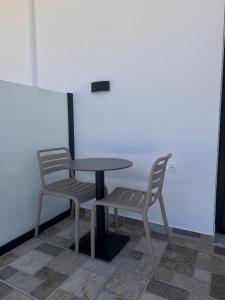 two chairs and a table and a table and chairs at Escape by Ambelas in Himare