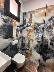 a bathroom with a toilet and a sink at Escape by Ambelas in Himare