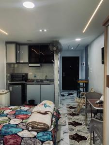 a kitchen with a couch in the middle of a room at Studio in Porto Said Compound in Port Said