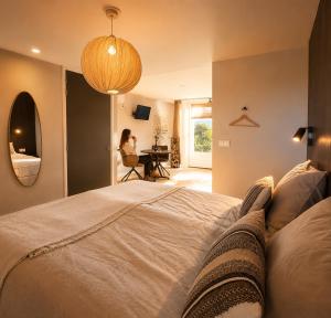 a woman is sitting at a desk in a bedroom at De Meuleberg Boutique Suites in Melick