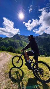 a man riding a bike on a dirt road at Almhütte Astental in Vordere Asten
