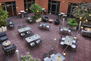 an overhead view of a patio with tables and chairs at NH Collection Nürnberg City in Nuremberg