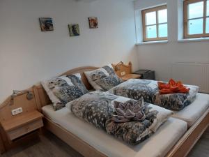 two beds with pillows on them in a room at Plösch Hof in Weinberg +21 photos