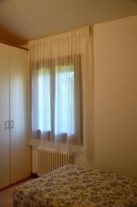 Schlafzimmer mit einem Bett und einem Fenster in der Unterkunft Agriturismo Alla Corte in Vicenza